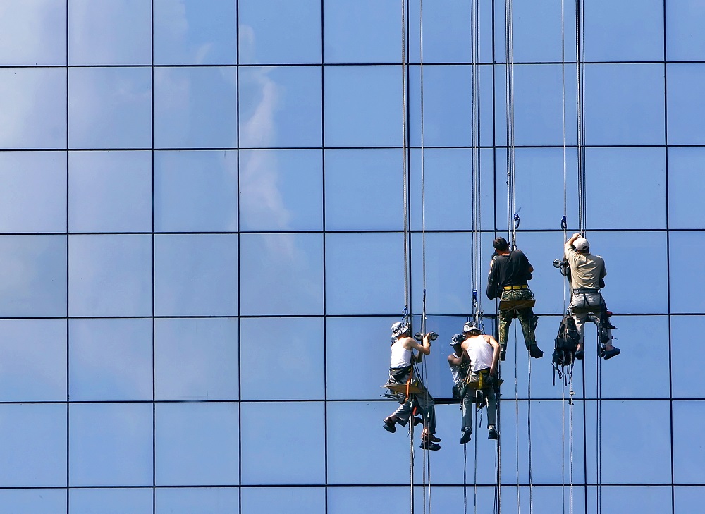 window washers on glass building facade