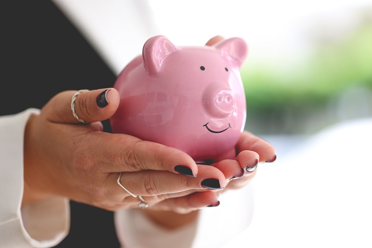 A business woman holding a piggy bank. Economy and finance.